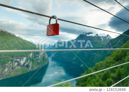 Red padlock and Geirangerfjord from Flydasjuvet viewpoint Norway Red padlock and Geirangerfjord from Flydasjuvet viewpoint Norway 128152698