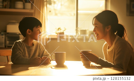 mother and son enjoying warm drinks together at home 128155132