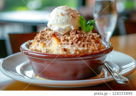 Delicious Peach Crumble with Vanilla Ice Cream, a Sweet Treat for Dessert Lovers. Delicious Peach Crumble with Vanilla Ice Cream, a Sweet Treat for Dessert Lovers. 128155895