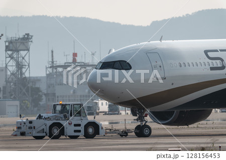 夕暮れの仙台空港 トーイングトラクターと飛行機 宮城県名取市 夕暮れの仙台空港 トーイングトラクターと飛行機 宮城県名取市 128156453