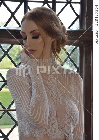 Beautiful, redheaded girl dressed in lace, posing in rooms of an old Manor House Beautiful, redheaded girl dressed in lace, posing in rooms of an old Manor House 128157354