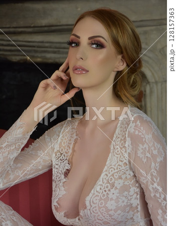 Beautiful, redheaded girl dressed in lace, posing in rooms of an old Manor House Beautiful, redheaded girl dressed in lace, posing in rooms of an old Manor House 128157363