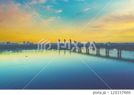 Skyline cityscape, Kyiv city in the morning, Paton bridge. Left bank of the Dnieper River. Aerial view Skyline cityscape, Kyiv city in the morning, Paton bridge. Left bank of the Dnieper River. Aerial view 128157660