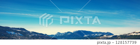 View of the mountains around Serre Poncon lake in winter. Hautes Alpes, France. Horizontal banner View of the mountains around Serre Poncon lake in winter. Hautes Alpes, France. Horizontal banner 128157739