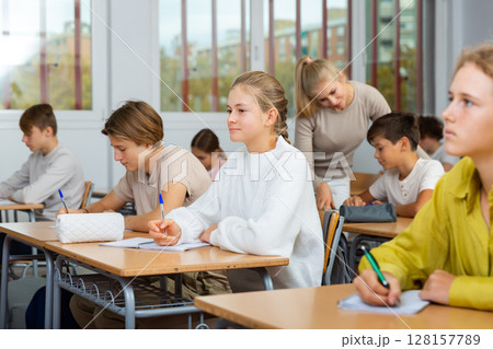 Young boys and girls studying in classroom Young boys and girls studying in classroom 128157789