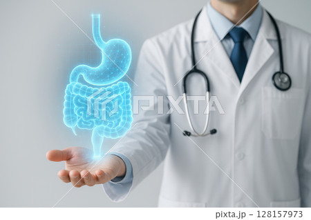 Holographic digestive system projection floating above hand of medical professional wearing white coat and stethoscope, symbolizing advanced healthcare and anatomy study 128157973