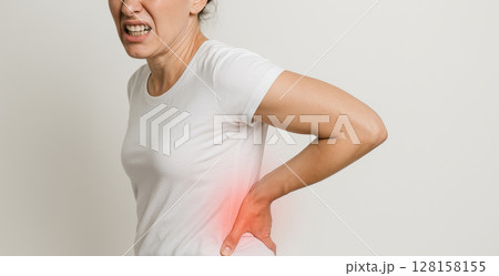 Woman pain back pain discomfort ache health injury white shirt adult female isolated expression suffering hurt body casual human person side studio adult only one person upper body indoors 128158155