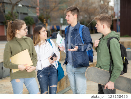 Teenage students talking outside after lessons 128158436