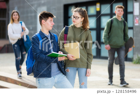 Teenage students talking outside after lessons 128158496