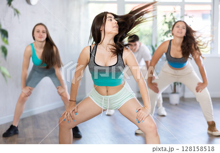 Group of young women and young guy dancing hip hop 128158518