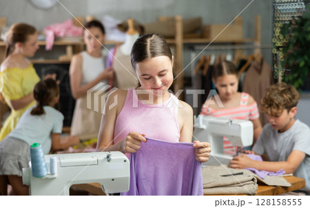 Teen girl child with cloth in hands Teen girl child with cloth in hands 128158555