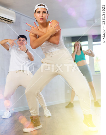 Young girl dancing krump with group in dance studio 128158623