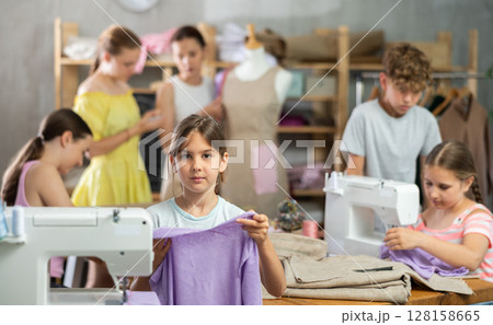 Girl child with cloth in hands 128158665