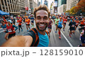 Young man marathon runner taking a selfie while running a marathon, capturing the vibrant atmosphere with a crowd of other runners and the big city skyline in the background, showcasing the excitement 128159010