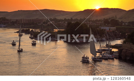felucca boats on Nile river in Aswan at sunset felucca boats on Nile river in Aswan at sunset 128160548