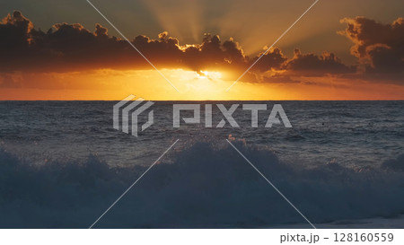 Sunset over sea waves with vibrant colors 128160559