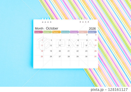 October 2026 desk calendar on blue and rainbow color background. October 2026 desk calendar on blue and rainbow color background. 128161127