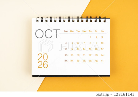 Desk calendar for October 2026 year on yellow color background, Flat lay. 128161143