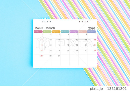 March 2026 desk calendar on blue and rainbow color background. 128161201