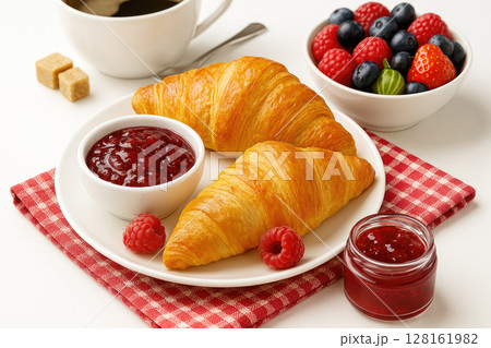 Delicious breakfast with croissants, berries, jam and a cup of coffee Delicious breakfast with croissants, berries, jam and a cup of coffee 128161982