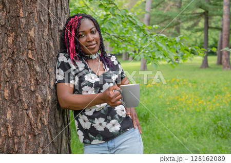 Black Woman Drinking Coffee in Nature Outdoor Relaxation Black Woman Drinking Coffee in Nature Outdoor Relaxation 128162089
