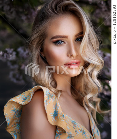 Graceful Young Woman in Floral Sundress 128162593