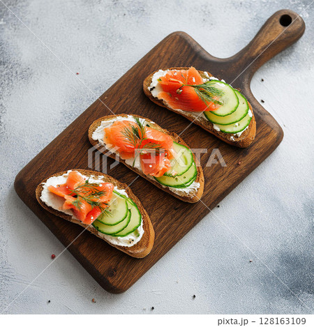 Elegant Bruschetta Arrangement on Wooden Board 128163109