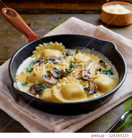 Creamy Ravioli Dish in Rustic Skillet 128163123