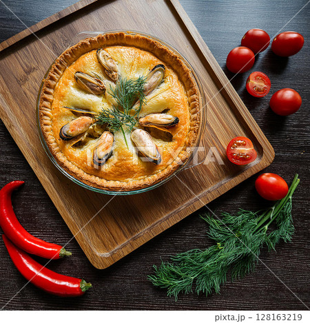 Golden Seafood Pie on Rustic Cutting Board 128163219