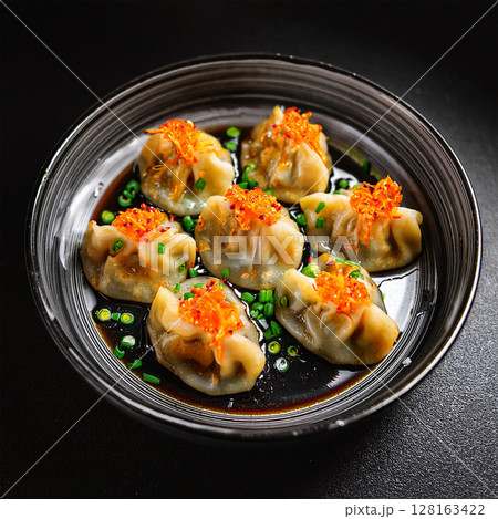 Delicious Asian Dumplings on Dark Plate 128163422