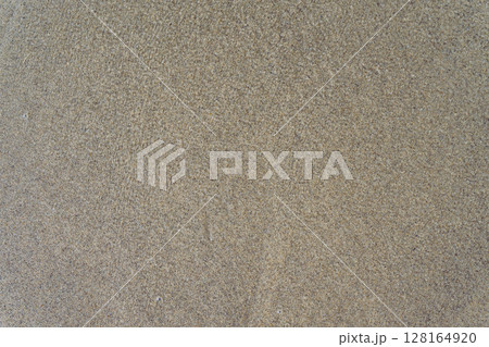 Sand under water, beige textured surface. Top down view Sand under water, beige textured surface. Top down view 128164920