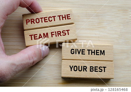 Protect the team first and give them your best text on wooden blocks, reinforcing the idea that effective leadership involves serving and uplifting others consistently Protect the team first and give them your best text on wooden blocks, reinforcing the idea that effective leadership involves serving and uplifting others consistently 128165468