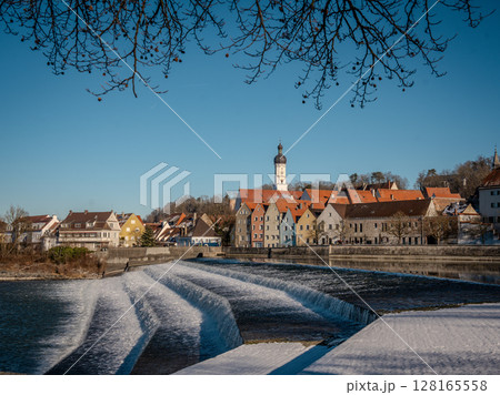Historic Town Of Landsberg Am Lech In Bavaria: Winter Charm With A Frozen River And Colorful Houses Under A Clear Blue Sky 128165558