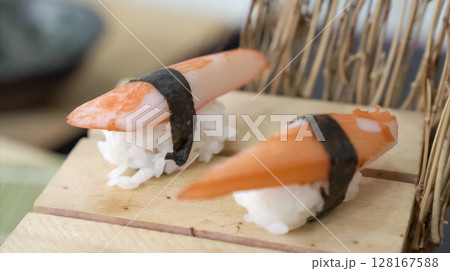Crab sushi, traditional Japanese food style. Sliced crab stick on rice display for photo shooting. Crab sushi, traditional Japanese food style. Sliced crab stick on rice display for photo shooting. 128167588