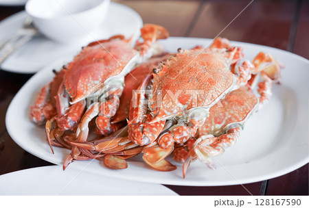 Fresh sea crabs cooked by charcoal grilling, served on the dish with Thai seafood dipping sauce at the famous local restaurant in Thailand. Fresh sea crabs cooked by charcoal grilling, served on the dish with Thai seafood dipping sauce at the famous local restaurant in Thailand. 128167590