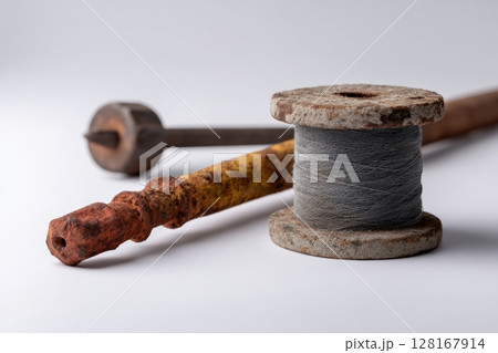 Vintage sewing tools and materials on a clean surface showcasing craftsmanship and history Vintage sewing tools and materials on a clean surface showcasing craftsmanship and history 128167914