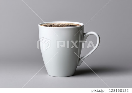 Warm cup of coffee on a gray background with rich black brew inside Warm cup of coffee on a gray background with rich black brew inside 128168122