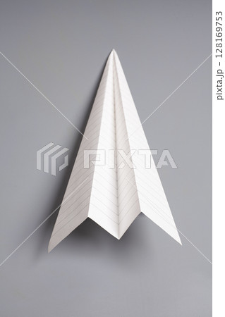 Origami paper airplane on gray background 128169753