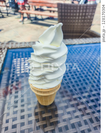 Ice cream cone on the table at summer time. 128170304