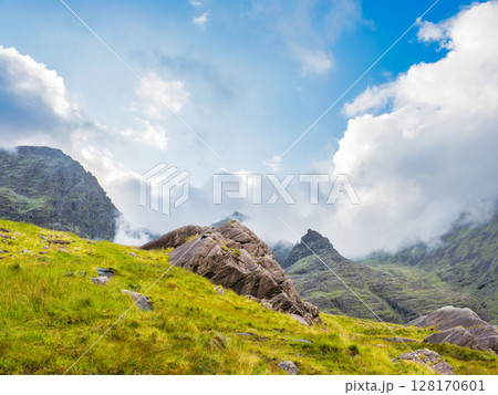 Approaching rugged beauty near Carrauntoohil peak with clouds, on popular irish walking trail in County Kerry, Ireland. 128170601