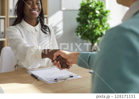 Multiracial hr deal, smiling african american woman shake hands starting collaboration Multiracial hr deal, smiling african american woman shake hands starting collaboration 128171131