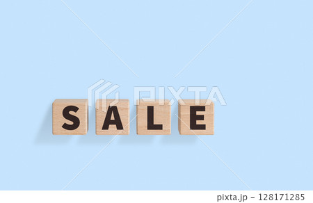 Wooden Blocks with SALE Text on blue Background for Promotional Designs 128171285