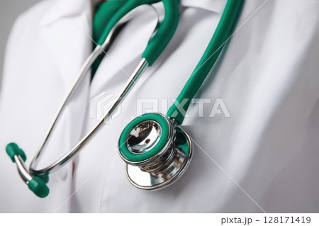 A stethoscope on a white lab coat symbolizes the essence of medical care and professionalism 128171419
