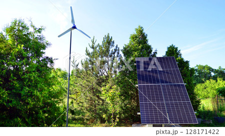 Solar panels with wind turbine on blue sky. Concept of clean energy. Green technology for future.  128171422