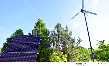 Solar panels with wind turbine on blue sky. Concept of clean energy. Green technology for future.  128171423