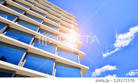 Downtown corporate business district architecture. Glass reflective office buildings against blue sky and sun light. Economy, finances, business activity concept. Abstract modern architecture fragment 128171576