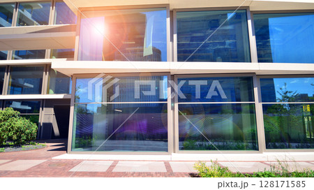 Downtown corporate business district architecture. Glass reflective office buildings against blue sky and sun light. Economy, finances, business activity concept. Abstract modern architecture fragment 128171585