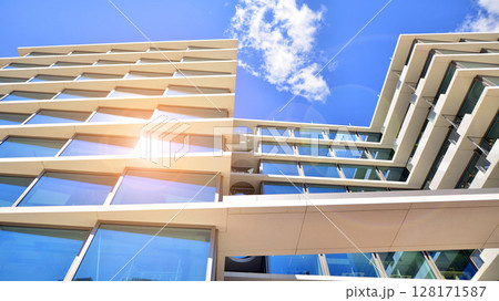 Downtown corporate business district architecture. Glass reflective office buildings against blue sky and sun light. Economy, finances, business activity concept. Abstract modern architecture fragment 128171587