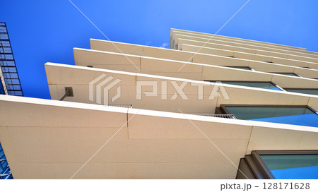 Downtown corporate business district architecture. Glass reflective office buildings against blue sky and sun light. Economy, finances, business activity concept. Abstract modern architecture fragment 128171628