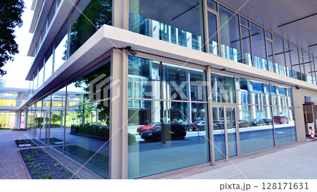 Downtown corporate business district architecture. Glass reflective office buildings against blue sky and sun light. Economy, finances, business activity concept. Abstract modern architecture fragment 128171631